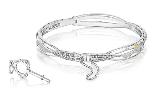 Silver bangle with TACORI sporting unique metalwork, plus a small key used to unlock the clasp