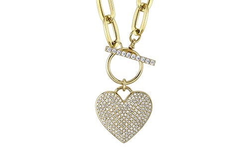 Yellow gold heart pendant imbued with diamonds attached to a gold ring with a dazzling chain