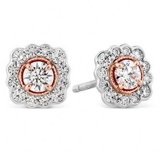 White gold and rose gold diamond earrings that have a slightly romantic and floral style to their stud earring design