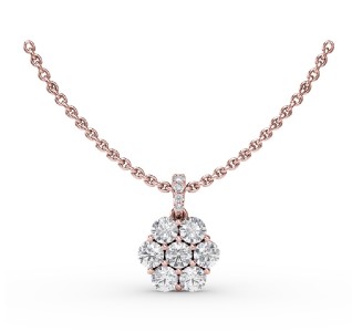 Seven round diamonds arranged like a flower for a pendant on a rose gold chain