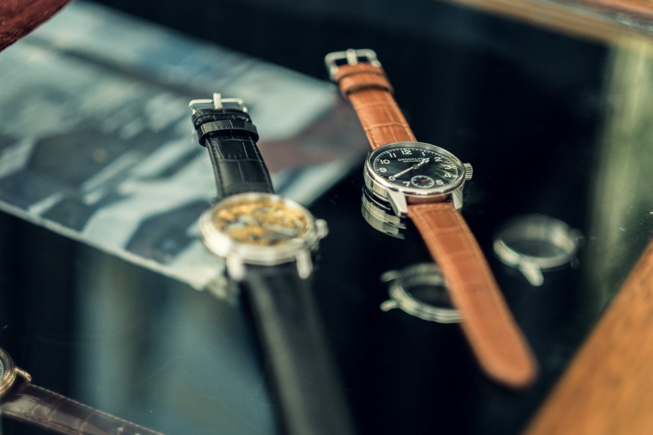 Two timepieces with leather straps