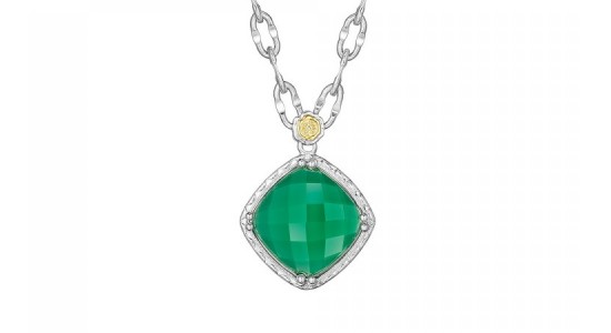 A green gemstone necklace in a silver setting with a small yellow gold brand detail