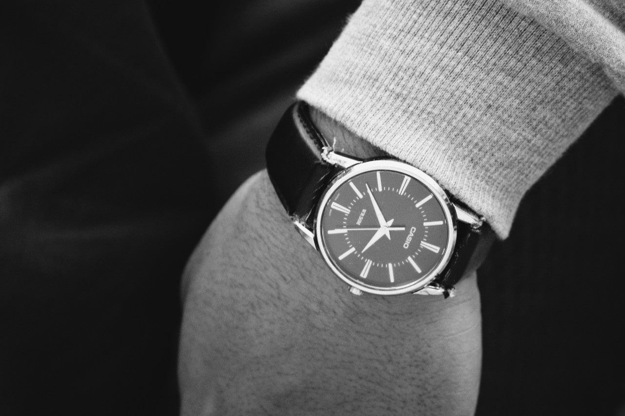 Fancy man wearing a black watch. Note that the photo is in black and white