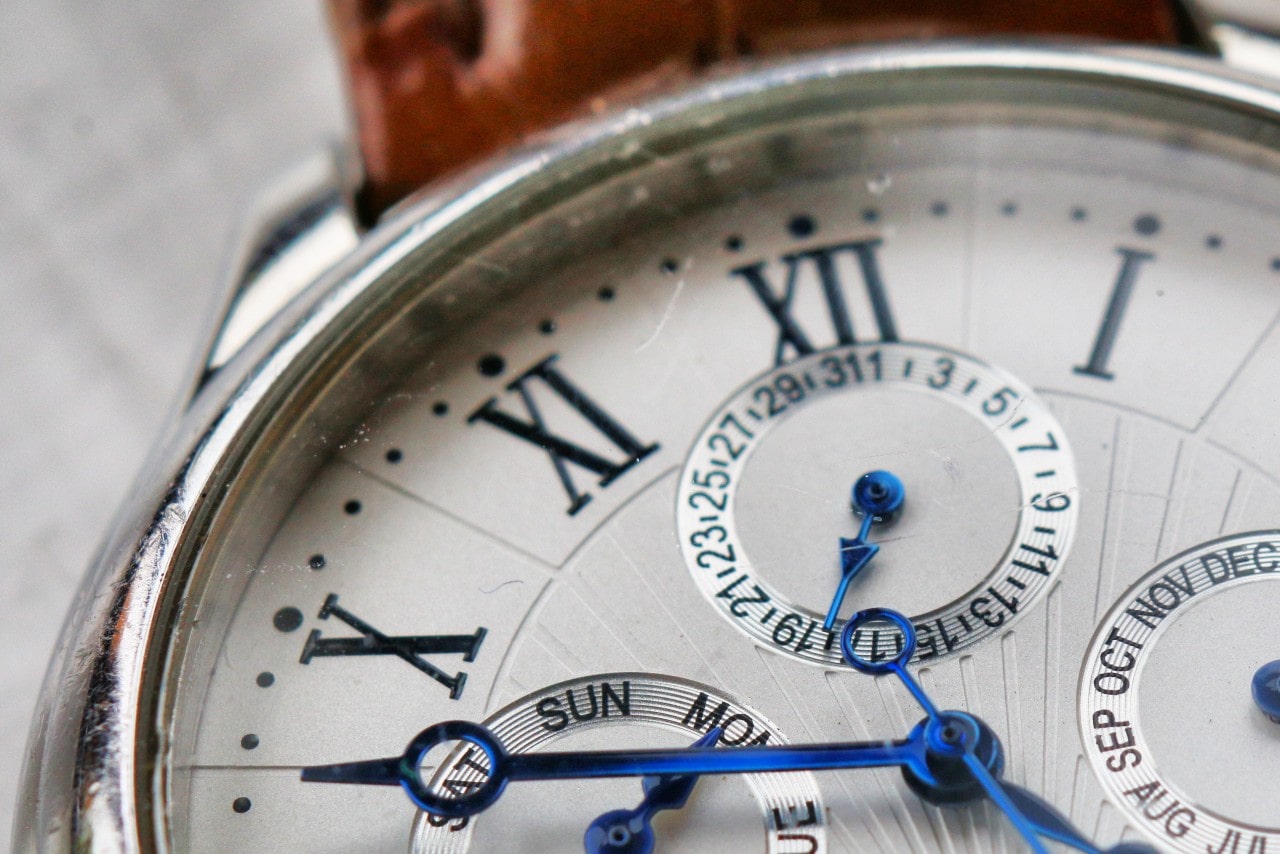 Close-up of a watch dial, revealing complications and detail