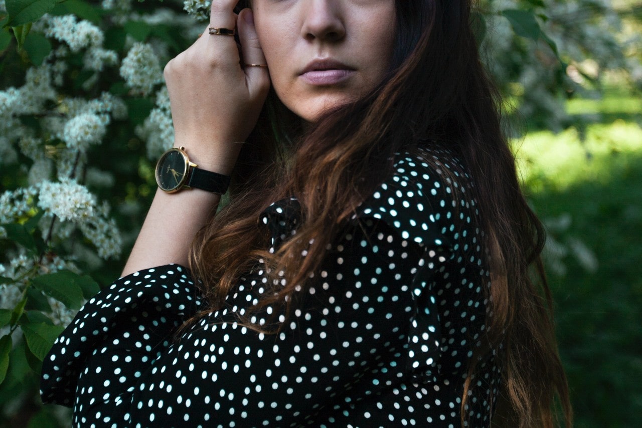 Woman wearing a black and gold watch