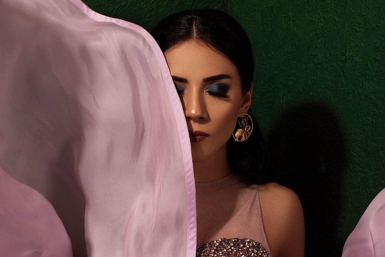 glamorous lady wearing large gold earrings and makeup