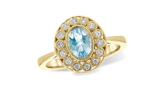 a yellow gold fashion ring featuring an oval cut aquamarine surrounded by diamond accents
