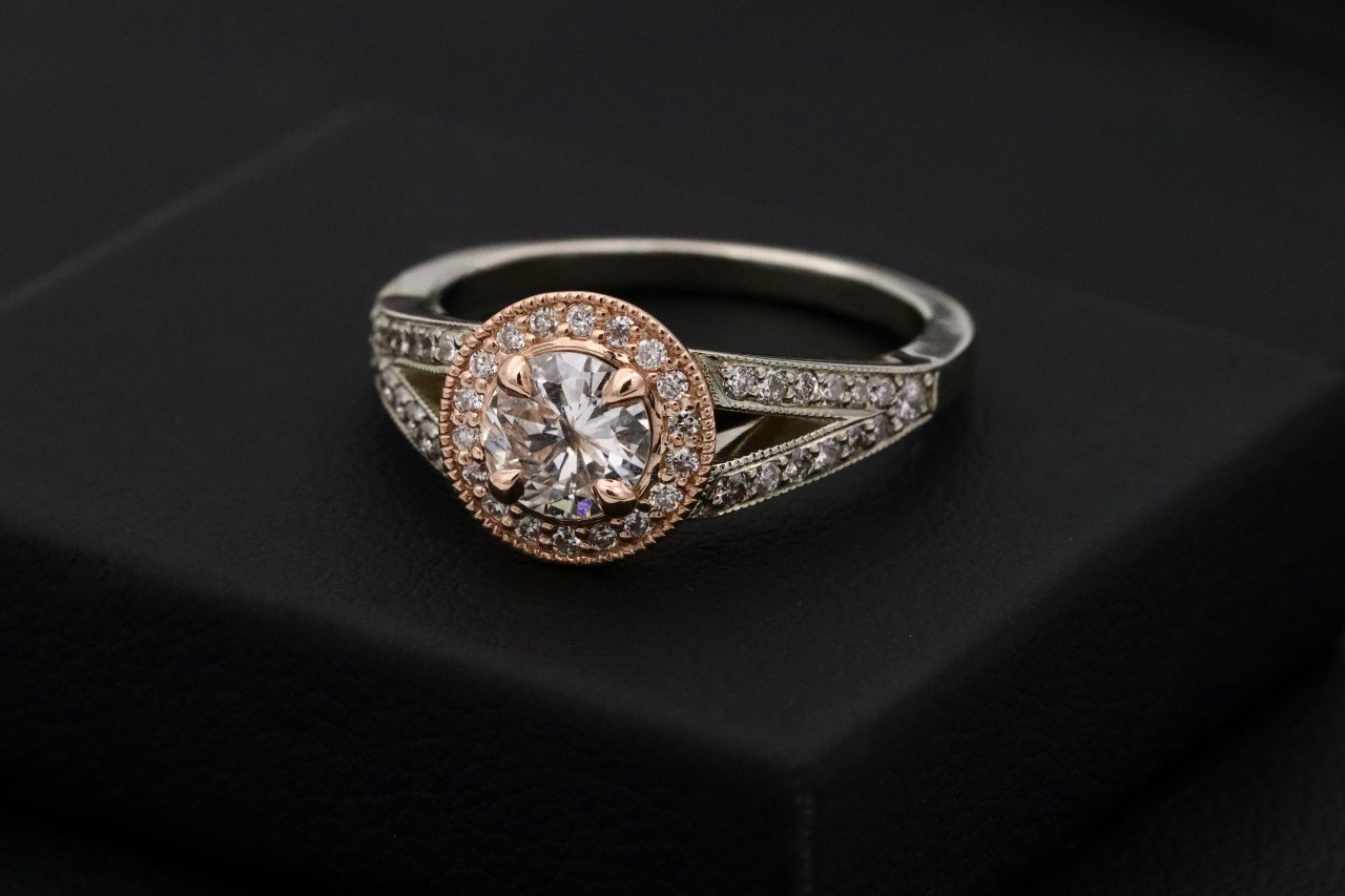 a brand new engagement ring on a black background