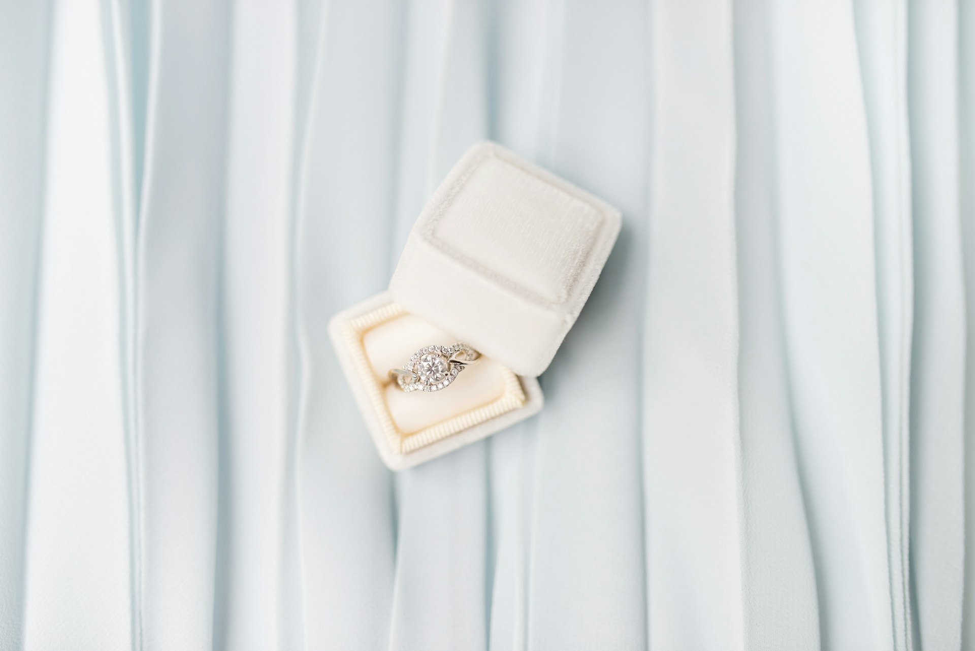 an engagement ring in a white box